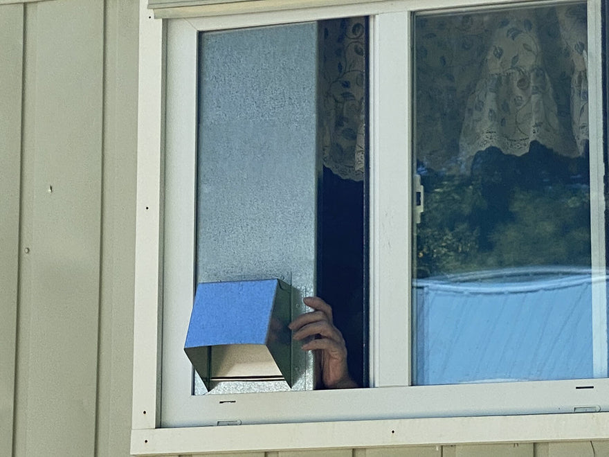 Vertical Window Vent Being Installed in a Slider Window